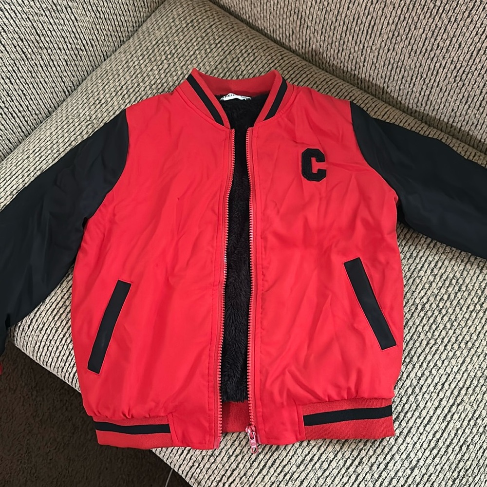 Black and red jacket with an “C” on the front.